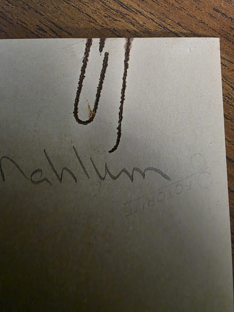 A red outline of a paperclip on a white background.