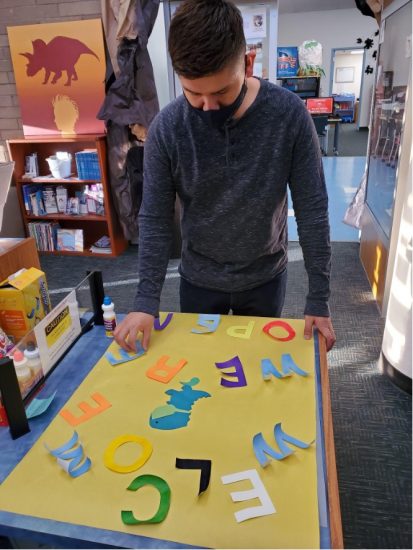 Our very own SLASC Blog Director, Max, is seen here creating a welcome display for the library's entrance.