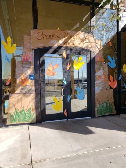 Library entry doors decorated with dinosaur footprints