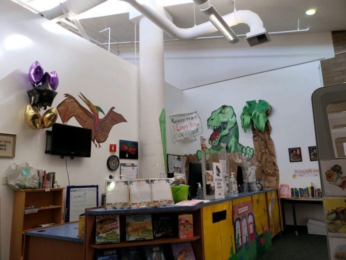 Reference desk decorated with dinosaurs