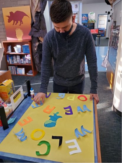 SLASC Blog Director Max Our very own SLASC Blog Director, Max, is seen here creating a welcome display for the library's entrance.
