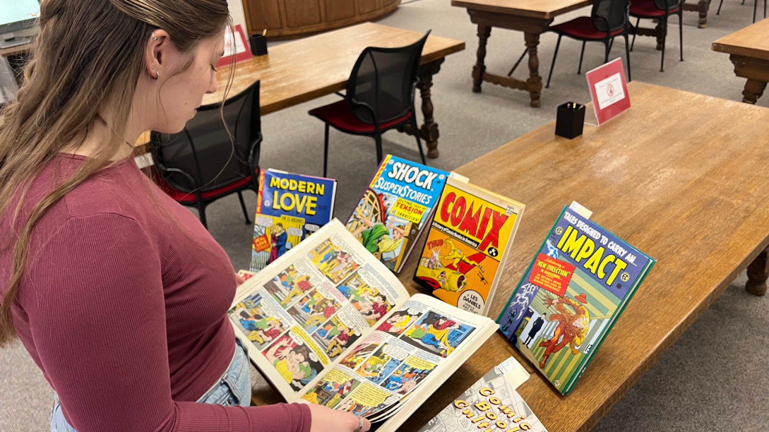 Student flipping through comics in the SDSU SCUA